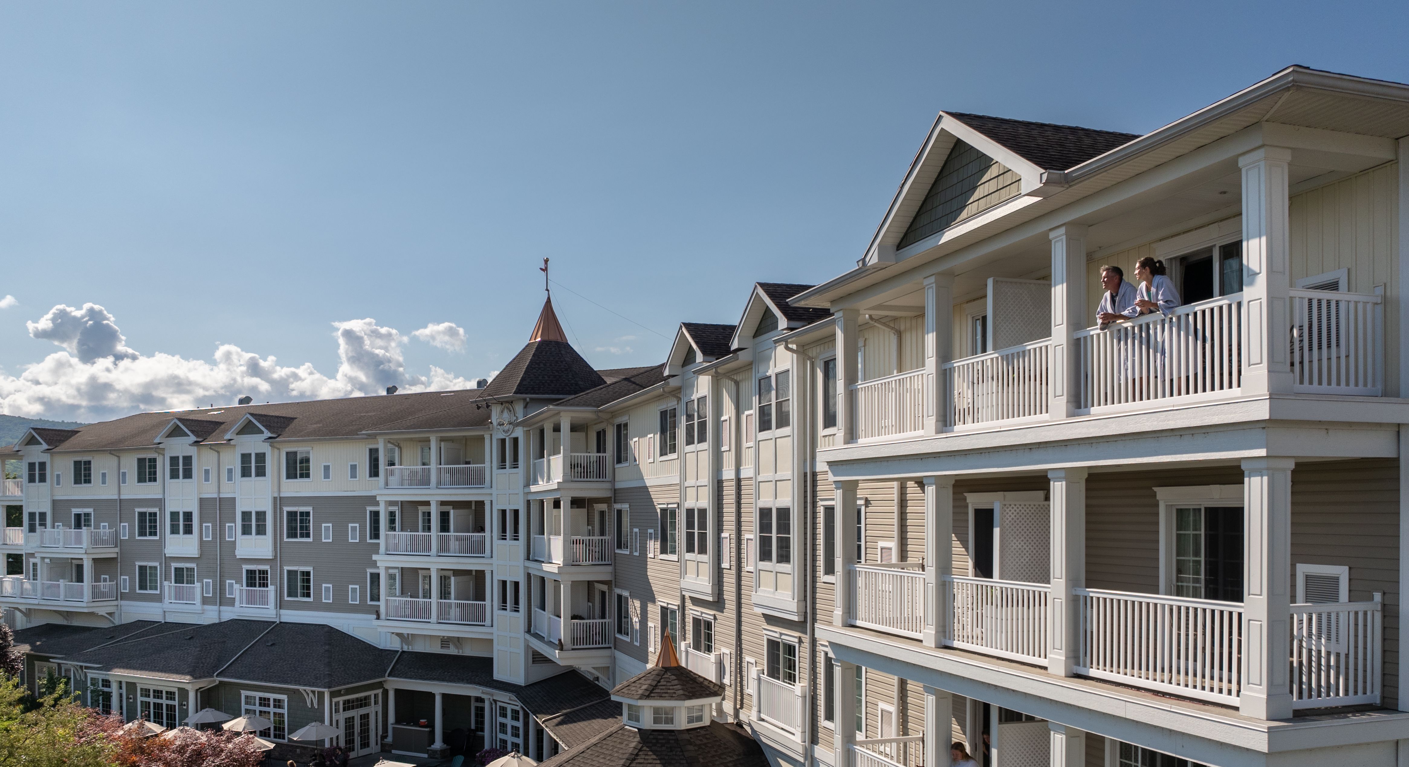 A couple admires the view from their 4th floor balcony at the Watkins Glen Harbor Hotel