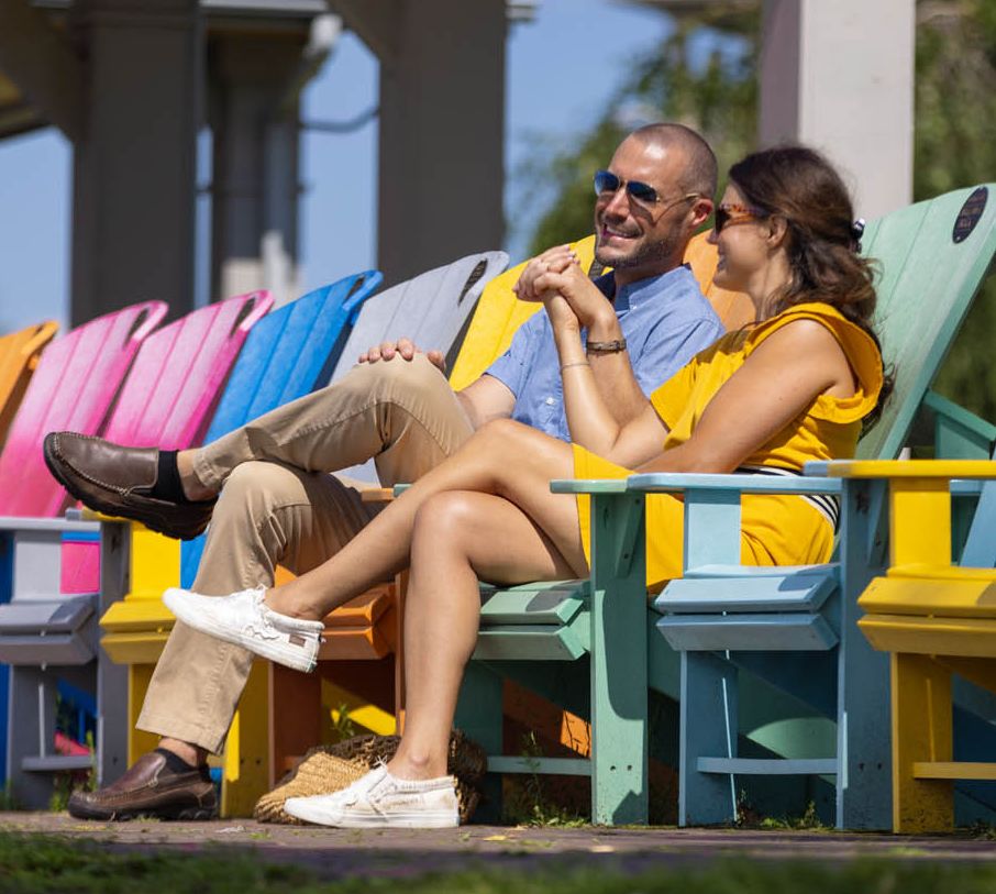 A couple watches boats go by on the St Lawrence River in the 1000 Islands region of New York