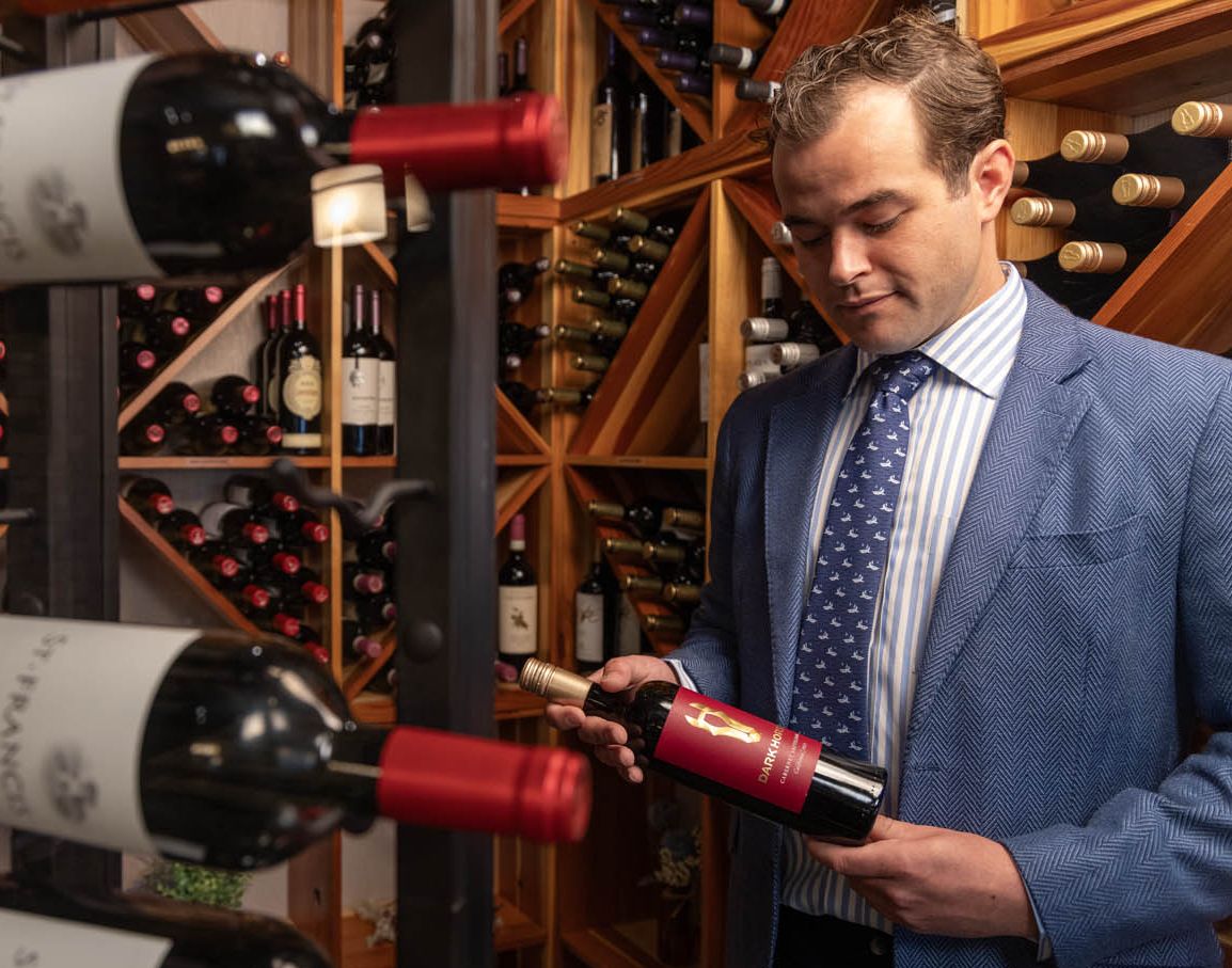 A sommelier examines a bottle of wine from our wine vault